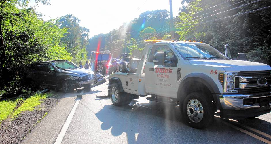 A tow truck removes a vehicle involved in a multi-vehicle accident which occurred Tuesday, July 2. Three people were injured and transported to Athol Hospital. 