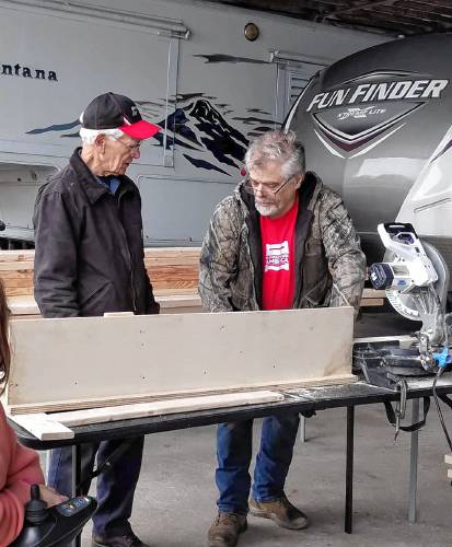 Walter Hubbard (left) and his son, Sleep in Heavenly Peace’s Orange-Athol Chapter Co-President Scott Hubbard, work on a section of a bed to be donated.