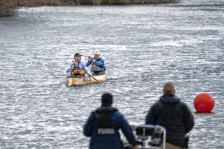 Canoe No. 3, paddled by Ryan Zaveral and Shane MacDowell, was the first to cross the finish line in the River Rat Race.