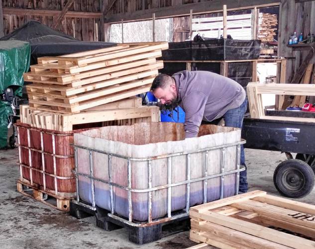 Eric Grenier stains parts for a bed. Founded in 2012, the Athol-Orange chapter is the only one that Sleep in Heavenly Peace has in Massachusetts.