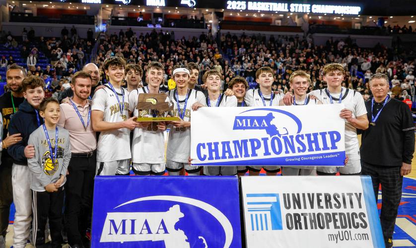 The Pioneer boys basketball team celebrates after beating Hopedale 49-28 to win the MIAA Division 5 state championship Saturday at the Tsongas Center in Lowell.