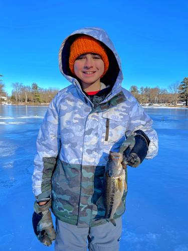 Braedon Rogowski with his 1.08-pound bass, the biggest fish caught at the derby.