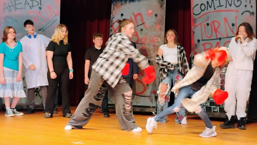 Zombie Addie L'Ecuyer (l) tussles with normal human Gwen Bowdridge.
