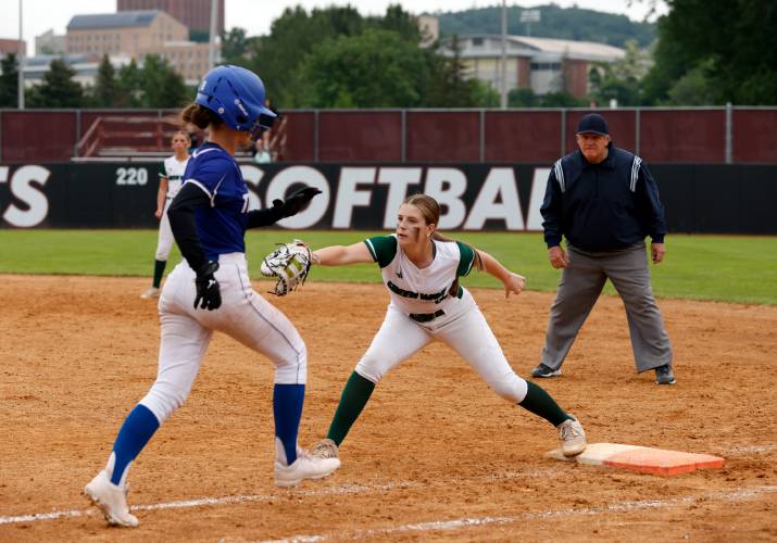 Greenfield first baseman Carson Farrell (19), right, stretches to field the throw at first for an out against Turners Falls during the MIAA Division 5 softball state championship Saturday at UMass.