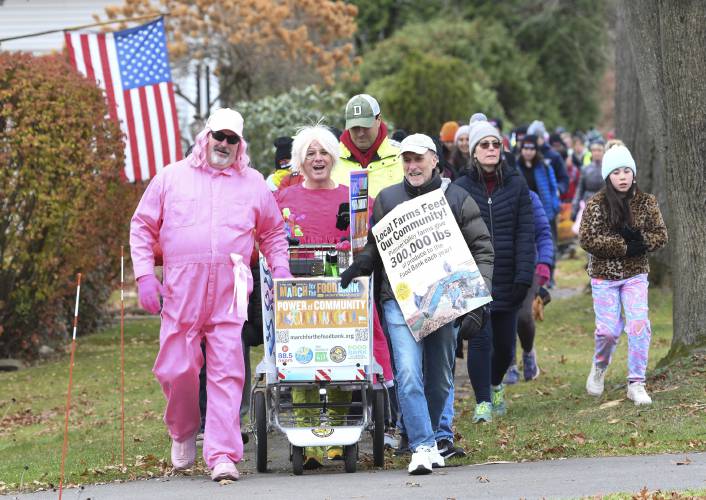 The 14th Annual March for the Food Bank with Monte Belmonte, second from left,  makes its way up North Main Street in South Deerfield in 2023. This year’s two-day march kicks off Monday and ends Tuesday night.