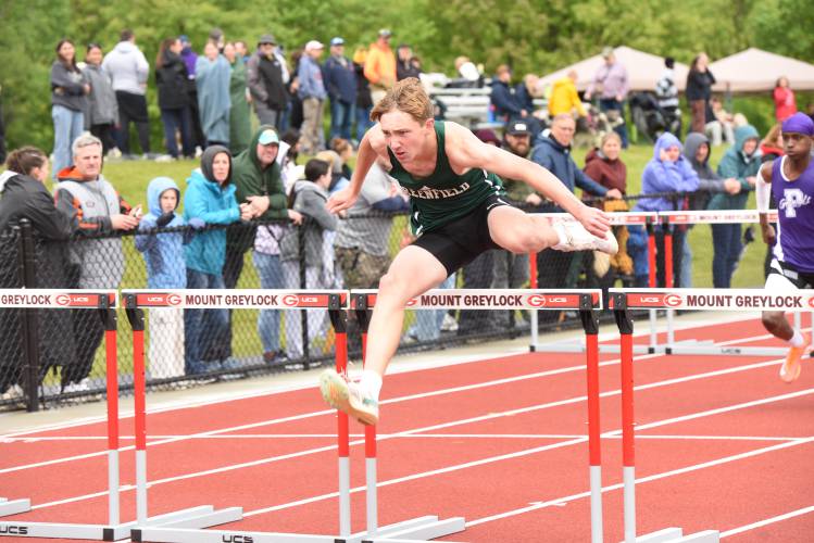 Greenfield’s Mason James Youmell leaps over a hurdle in the boys 110 meter hurdles at the Division 2 Western Massachusetts championships at Mount Greylock Regional School on Saturday afternoon.