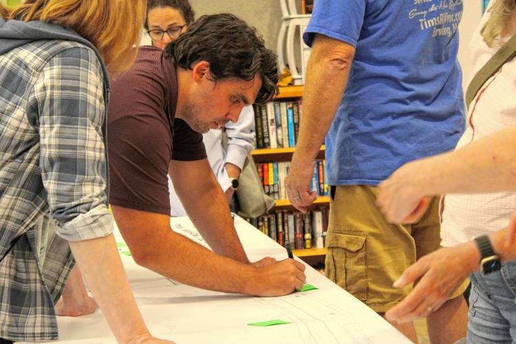 Green International Affiliates Inc. Project Manager Nick Millhollin writing down feedback from community members about the proposed Route 2 redesigns in Erving on Wednesday night. 