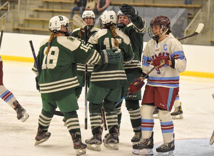Deerfield Academy players celebrate a first-period goal from Sophie Frost (15) against NMH during the Big Green’s NEPSAC victory on Wednesday at the Class of 1993 Hockey Rink in Deerfield.