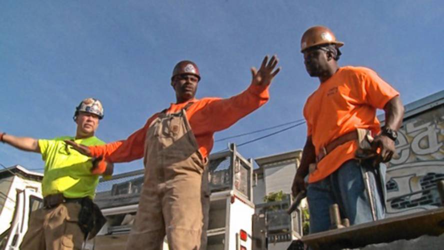 Roxbury native Ed Jordan, middle, directs crew members of his construction company. Jordan, a former prison inmate in Walpole, is featured heavily in the documentary film “Holding Up The Sky,” which also features friend and fellow inmate Jimmy Costello, left. The film will be shown as part of a program at Orange Innovation Center on June 30.