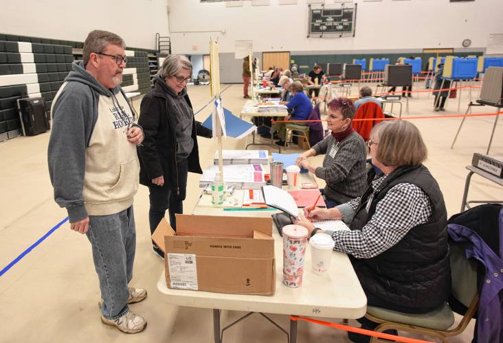 John and Caroline Abercrombie check in to vote at Greenfield High School on Tuesday.