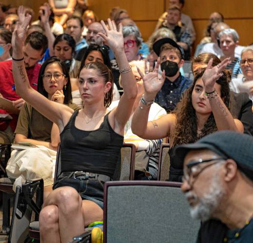 UMass students Emmanuelle Sussman and Ruya Hazeyen show support for faculty members during a question-and-answer period at a special meeting of the Faculty Senate on Tuesday, where Chancellor Javier Reyes and members of his administration made a presentation and answered questions about the campus protest and policing actions occurring on May 7 and 8.