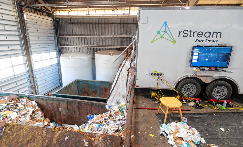 Sorted trash and recycling fall out the backside of the rStream trash sorter trailer Friday at UMass. The trailer “sorts up to a half-ton of waste per hour,” according to a UMass news release.