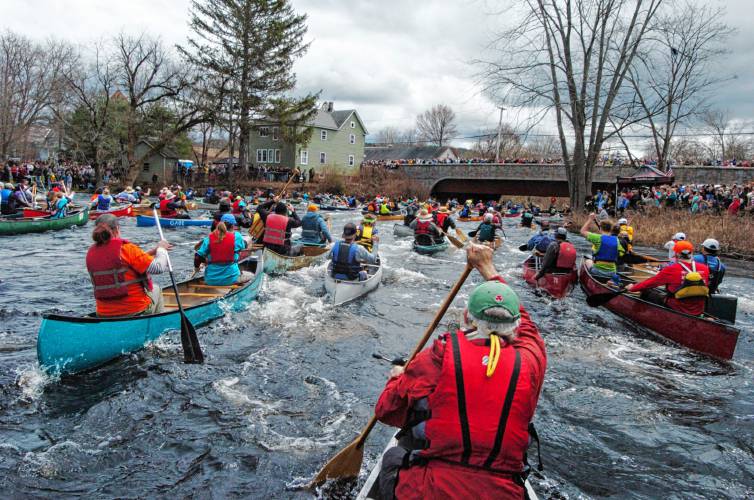 Canoes approach the bridge in Athol at the start of the River Rat Race on Saturday.