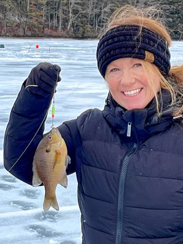 Jen Roche poses with her first ice fishing jigging catch – an ice bluegill.