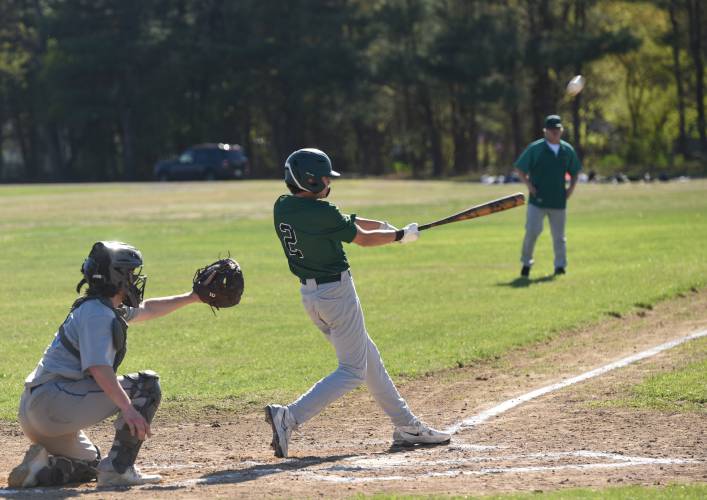 Greenfield’s Nico Siano (2) singles to left field to bring home a run during the Green Wave’s 10-0 win over Granby on Monday afternoon in Granby.