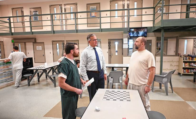 Franklin County Sheriff Christopher J. Donelan, center, talks with inmates Gary Palazzo, left, and Michael Clarke in D Pod at the Franklin County Jail and House of Correction in Greenfield.