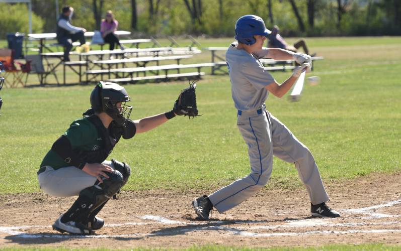 Granby’s Brodie Funk (2) fouls tips a pitch into Greenfield catcher Luca Siano’s mitt during the Rams’ loss to the Green Wave on Monday afternoon in Granby.