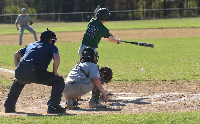 Greenfield’s Caleb Thomas (12) hits a ground ball to the left side of the infield during the Green Wave’s 10-0 win over Granby on Monday afternoon in Granby.