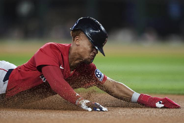 Boston Red Sox's Kristian Campbell slides into third, reaching on a Wilyer Abreu single in the fourth inning of a baseball game, Friday, March 28, 2025, in Arlington, Texas. (AP Photo/Tony Gutierrez)
