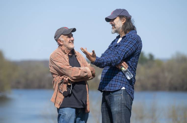 Writer Richard McCarthy, left, and actor Gary Gulman talk in between filming sessions during production for the short-film “Irving Berlin's View of the East River” near the Connecticut River, Thursday, April 24, 2025, in Hadley.
