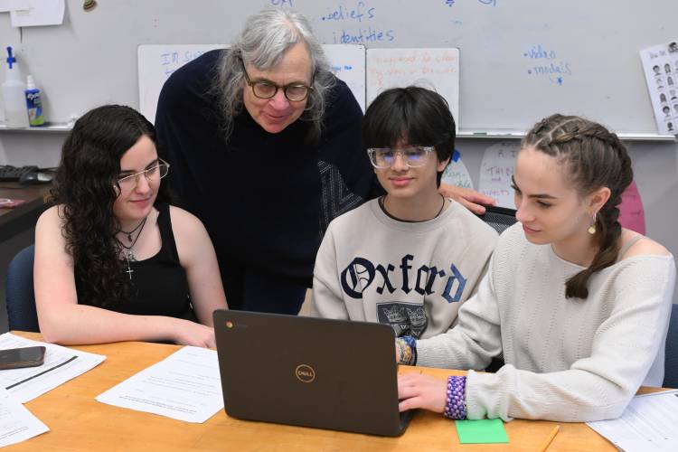 Athol High School student Kaitlyn Rossi, student advisor Beth Gospodarek, and students Om Patel and Piper Bailey, working on the Athol Advocate newspaper.