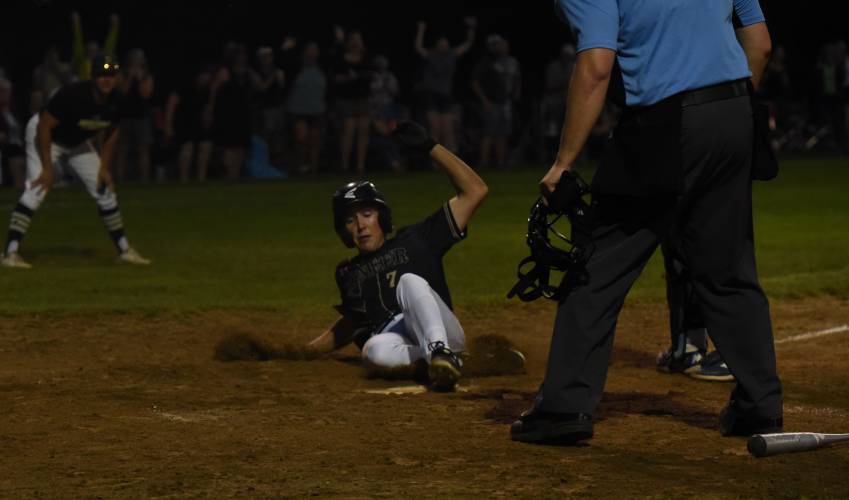 Pioneer’s Ben Werner slides home safely for the game-winning run after a Jackson Campbell single during the Panthers’ extra innings victory over Georgetown in the MIAA Division 5 Round of 16 on Thursday night in Northfield.