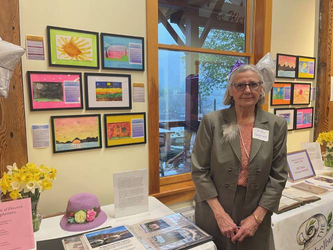 Shelburne Falls Area Women’s Club President Christine Baronas, pictured in front of the historical display.