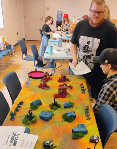 Jake Nonni of Athol gives Malcolm McNamara a lesson in the game Trilaterum.