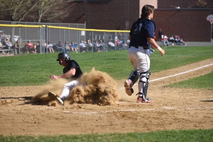 Pioneer's Jackson Glazier slides into home against Frontier in South Deerfield Wednesday. 