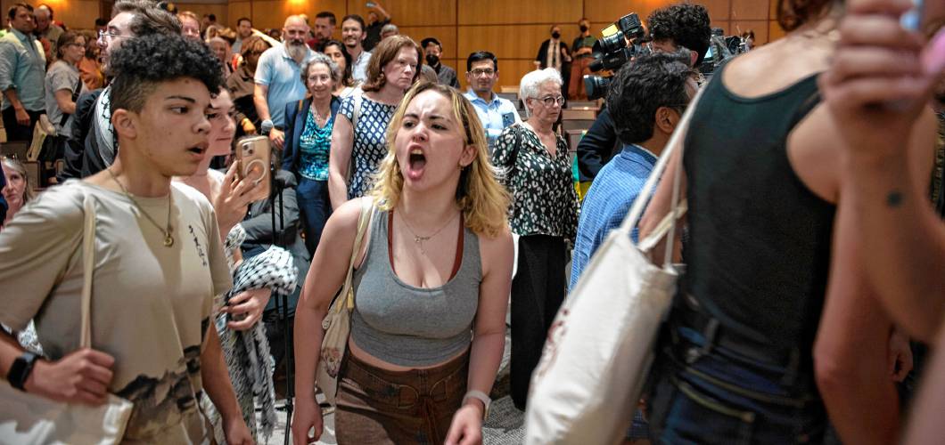 UMass students chant and yell as they leave Mahar Auditorium after a special meeting of the Faculty Senate, where Chancellor Javier Reyes and members of his administration explained their actions in halting a student protest on May 7-8.