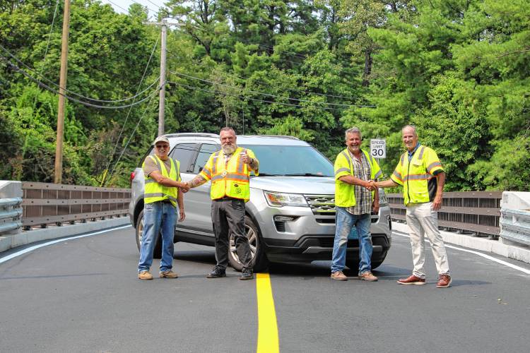 (L-R)State bridge inspector Herbie Pierce, Assistant Public Works Superintendent Paul Raskevitz, Construction Dynamics Superintendent Bob Ciampaglia and Public Works Superintendent Dick Kilhart on the Pinedale Avenue Bridge on Aug. 15, when it was reopened to the public.