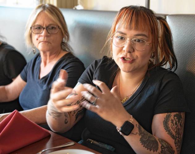    Akasia McQuaid talks about why she and the other servers at Eastside Grill in Northampton  feel strongly about voting no on Question 5 on Election Day. To the left is  Diane Frary. 
