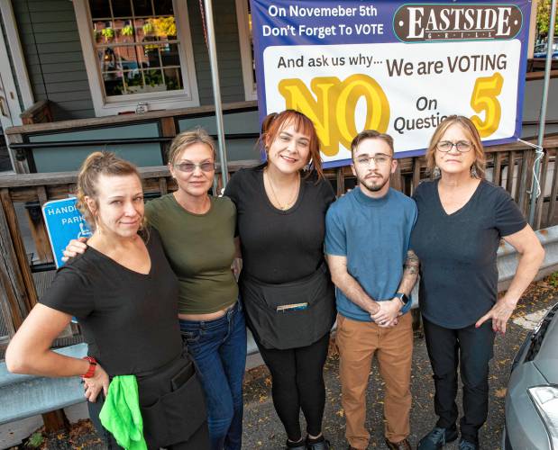 Long-term servers at Eastside Grill in Northampton, from left, Jill Slattery, Aly Didkovskyi, Akasia McQuaid, Mad Lawrence and Diane Frary say they will vote against Question 5 on Election Day. The ballot initiative seeks to raise the minimum hourly wage for tipped workers until it equals that of all Massachusetts workers. 