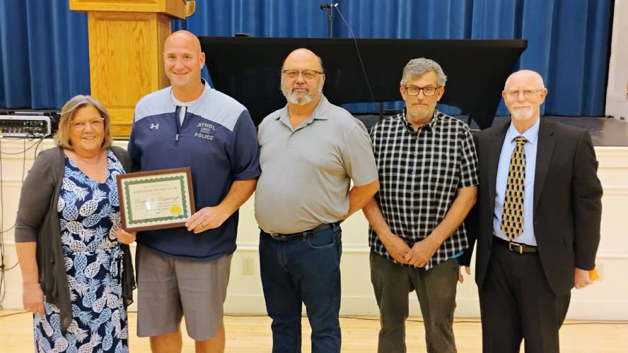 Athol Police Det. Sgt. Douglas Kaczmarczyk accepts the Margaret Grazis Employee of the Year Award from Athol's Selectboard at the beginning of Monday's Annual Town Meeting. Athol Police Det. Sgt. Douglas Kaczmarczyk accepts the Margaret Grazis Employee of the Year Award from Athol's Selectboard at the beginning of Monday's Annual Town Meeting.