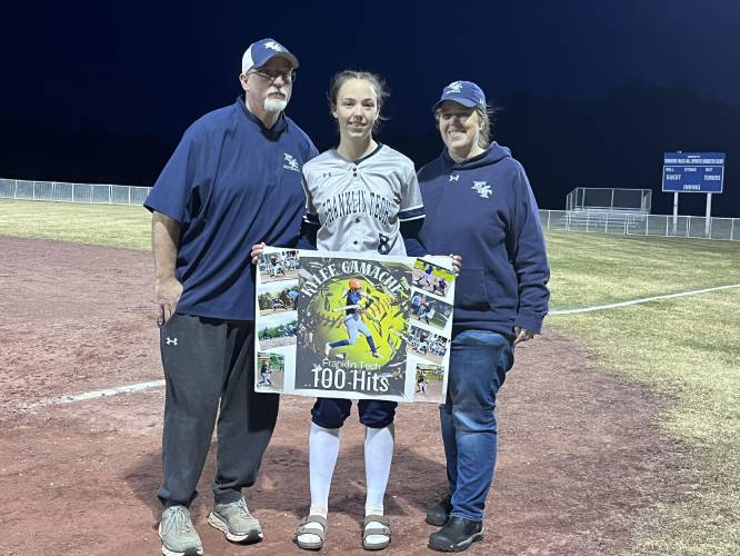 Kylee Gamache with her dad, Joe Gamache, and mom, Amanda, after knocking her 100th career hit on Friday in Turners. 