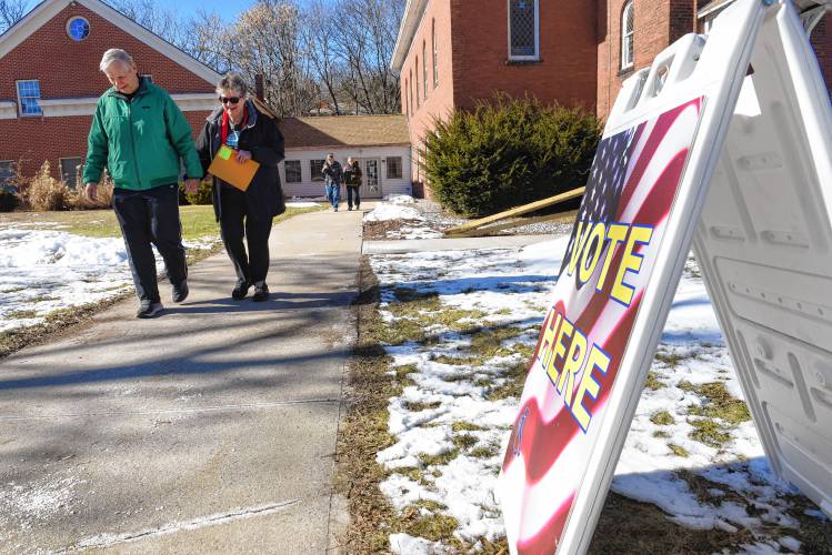 People leave after voting at 62 Cheney St. in Orange on Monday. 