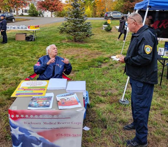 Royalston Police Chief Curtis Deveneau chats with community activist Gary Winitzer during Tuesday's National Night Out event in Royalston on Oct. 1.