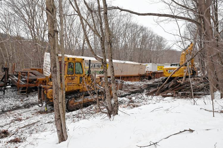 Heavy equipment is used to clean up derailed freight cars off Farley Road in Wendell on Wednesday.