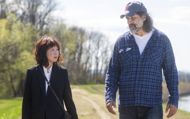 Actors Camryn Mi-young Kim, left, and Gary Gulman perform during production for the short film “Irving Berlin's View of the East River” near the Connecticut River, Thursday, April 24, 2025, in Hadley.