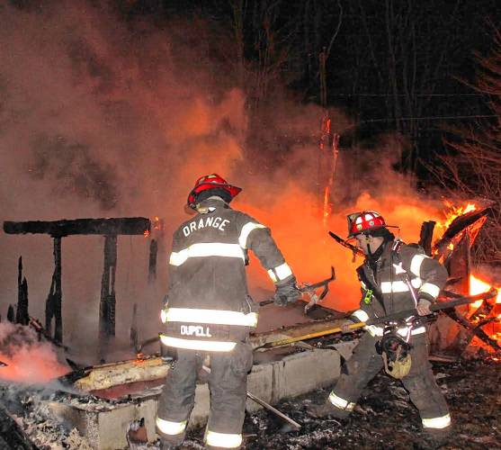 Orange firefighters work the scene of a two-alarm fire on Old South Road Wednesday morning. Neighbors reported the building had been vacant for years.