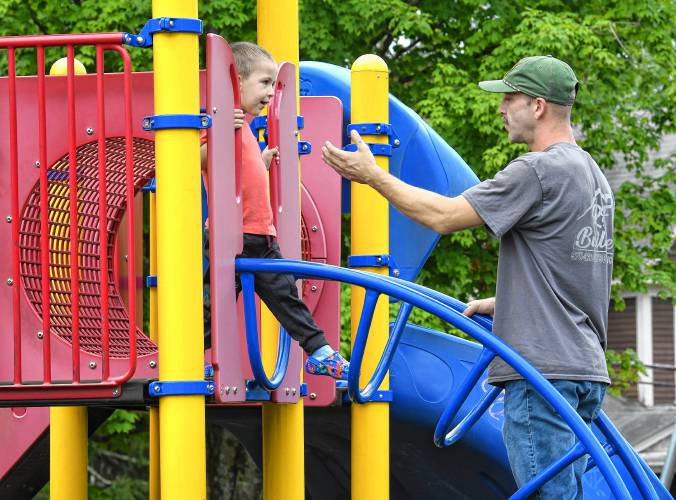 Colson Manjourea, 3, of Athol, is a little hesitant as his father, Jordan Manjourea, offers a helping hand on the playground equipment at Silver Lake Park on Thursday. Colson Manjourea, 3, of Athol, is a little hesitant as his father, Jordan Manjourea, offers a helping hand on the playground equipment at Silver Lake Park on Thursday.