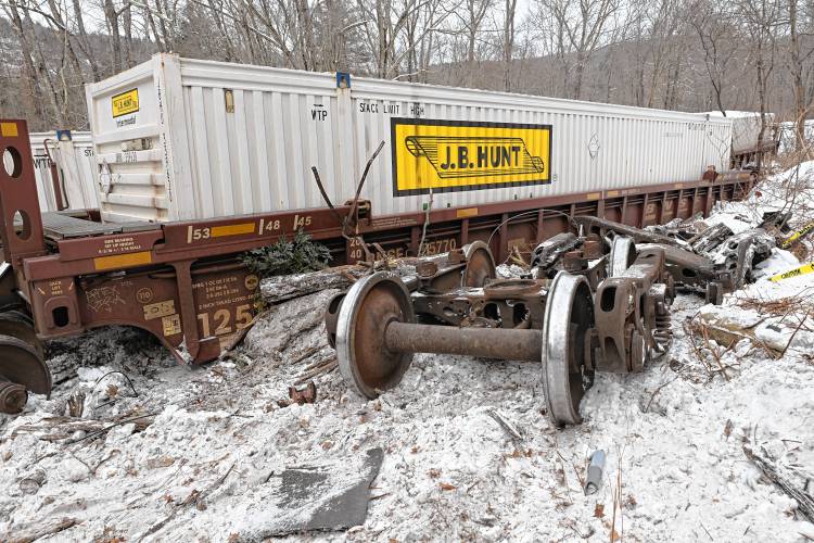 Rail cars and wheels lay along the damaged rail road tracks off Farley Road in Wendell where 15 freight cars derailed Tuesday. 