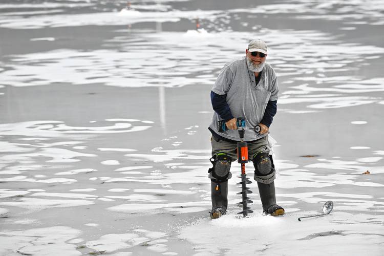Wakefield resident John Narkun drills another hole for a tip-up on Lake Mattawa in Orange on Wednesday. The ice was 15 inches thick on the western end of the lake. Wakefield resident John Narkun drills another hole for a tip-up on Lake Mattawa in Orange on Wednesday. The ice was 15 inches thick on the western end of the lake.
