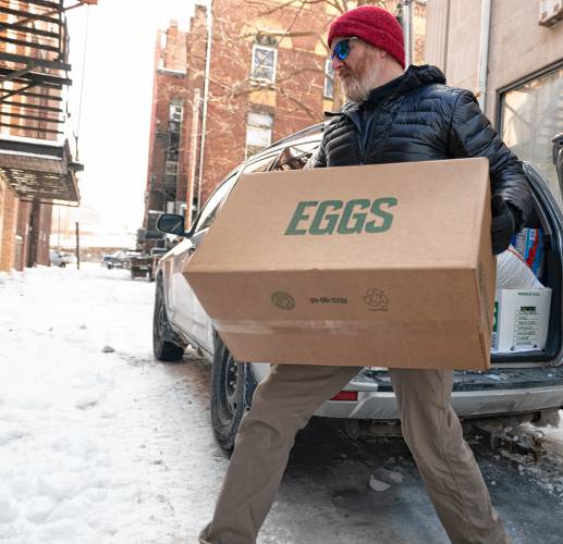 Chris Ware, owner of Jake’s in Northampton, unloads cases of eggs he got from Restaurant Depot in Chicopee on Tuesday morning. Over the last few weeks, Ware said the main ingredient in the restaurant’s  dishes has become 300% more expensive than in 2024.