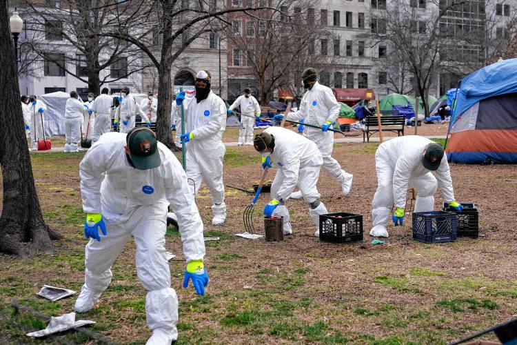 Workers clear a homeless encampment at McPherson Square in Washington, Wednesday, Feb. 15, 2023. (AP Photo/Patrick Semansky)