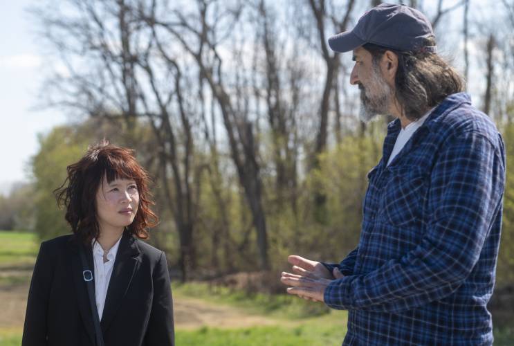 Actors Camryn Mi-Young Kim, left, and Gary Gulman perform during production for the short film “Irving Berlin's View of the East River” near the Connecticut River, Thursday, April 24, 2025, in Hadley.