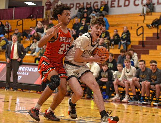 Pioneer’s Brayden Thayer (10), right, dribbles to the basket while defended by Hoosac Valley’s Qwanell Bradley  (25) during the Panthers’ 68-53 loss in the Hoophall Classic at Springfield College’s Blake Arena on Thursday.