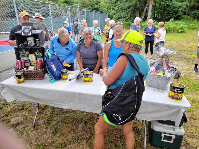 People at the grand opening of the refurbished pickleball courts at Silver Lake Park bought raffle tickets to win pickleball equipment, pickles and pickle-flavored snacks.