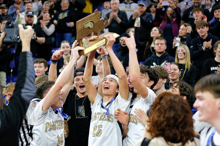 Pioneer players celebrate with fans after their 49-28 win over Hopedale for the MIAA Div. 5 state championship Saturday at the Tsongas Center in Lowell. 