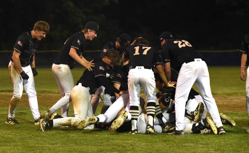 Pioneer baseball players pile on top of Jackson Campbell after Campbell hit a walk off during the Panthers’ extra innings victory over Georgetown in the MIAA Division 5 Round of 16 on Thursday night in Northfield.